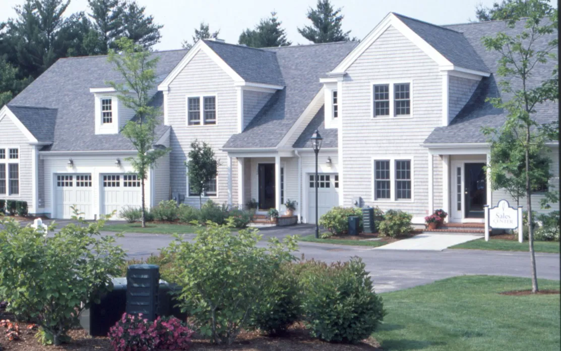 New England attached homes with covered porches at GreatBrook 55-plus community Norton MA
