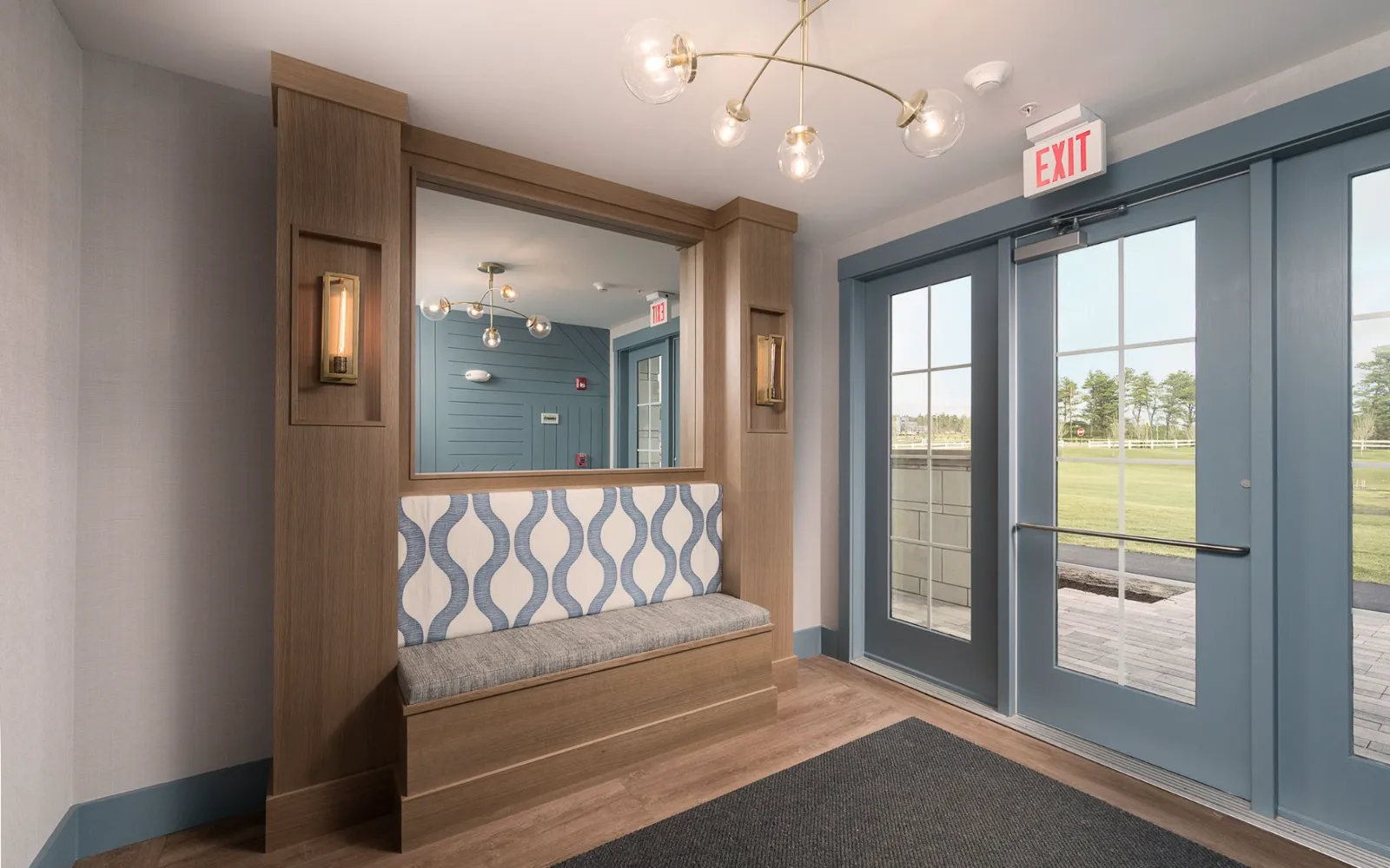 Stylish entry vestibule with tile accent and seating in Sawyer's Reach condo Plymouth MA