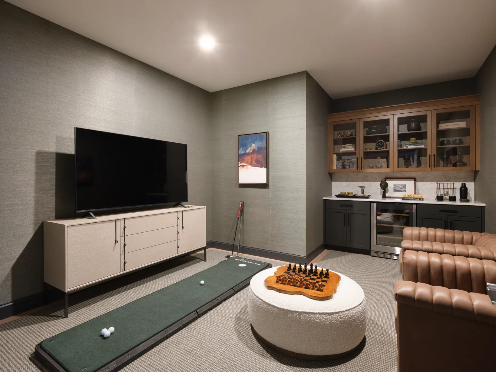 Den with textured wallpaper and built-ins in a Featherwinds 55+ condo in Halifax MA