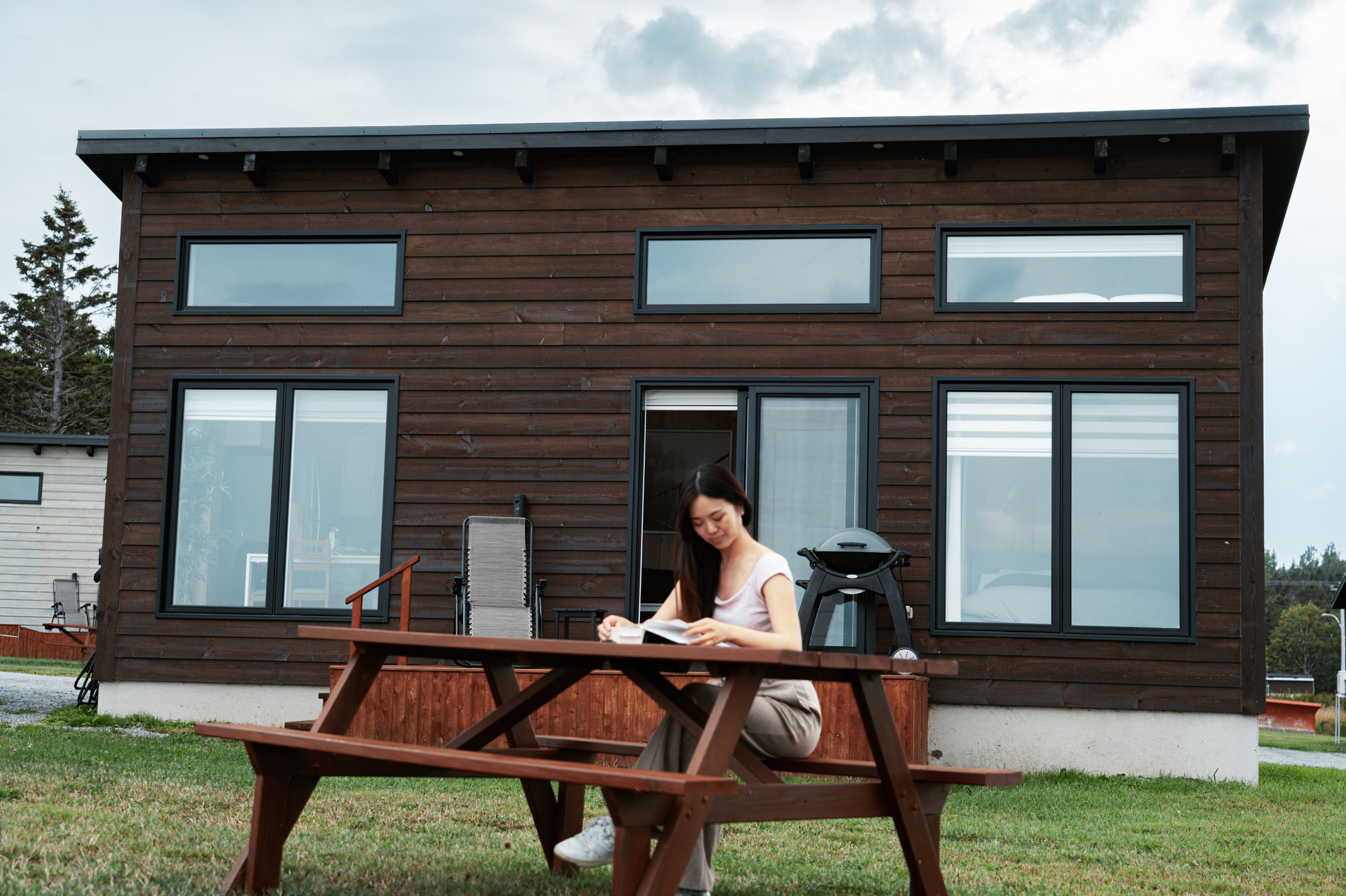 Picnic table in front of a dark wooden cabin