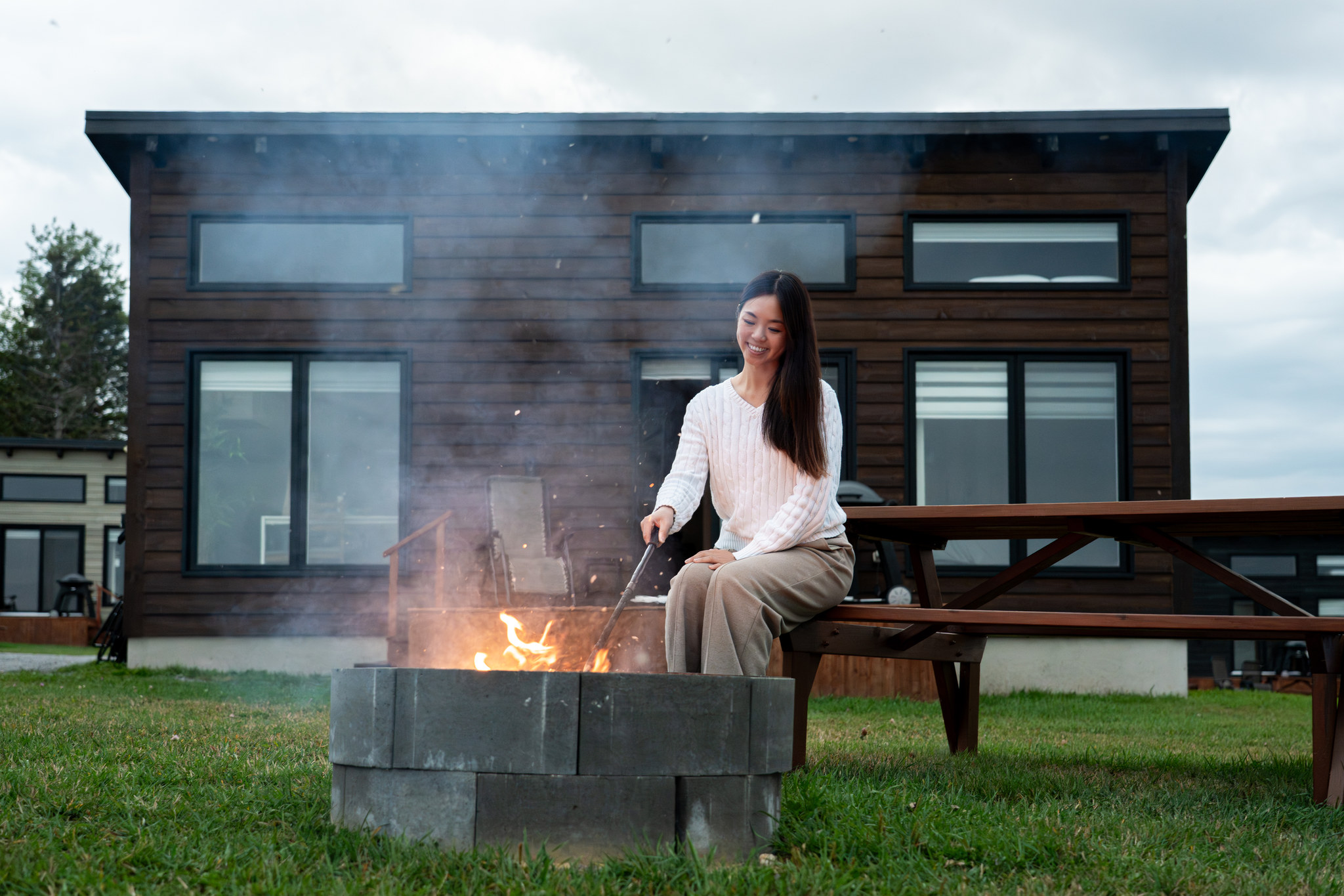 An outdoor fire burning in front of a cabin at Chalets Nautika
