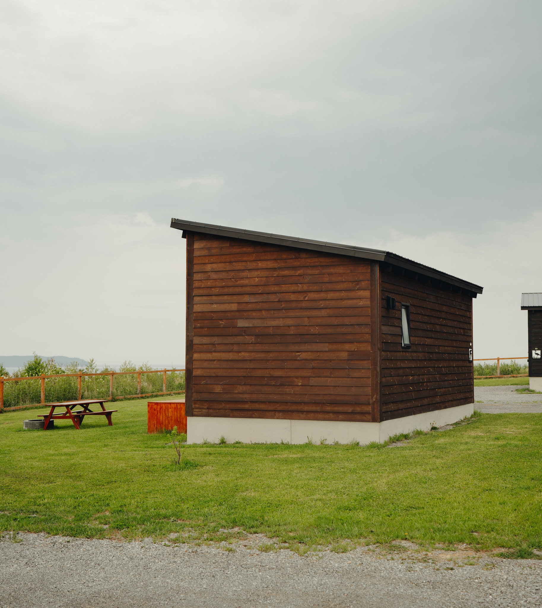 Exterior of a simple chalet with dark wood siding