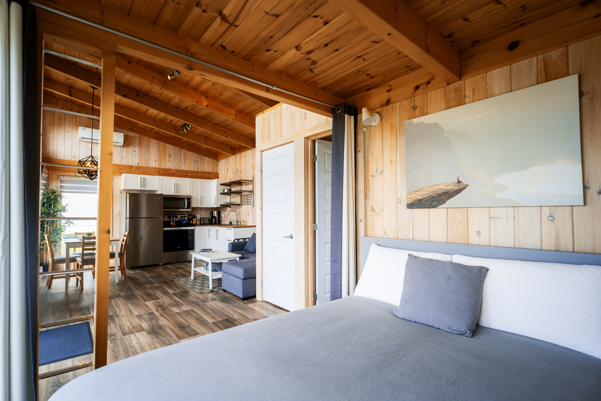 Sleeping area that opens onto the living room and kitchen of the cabin