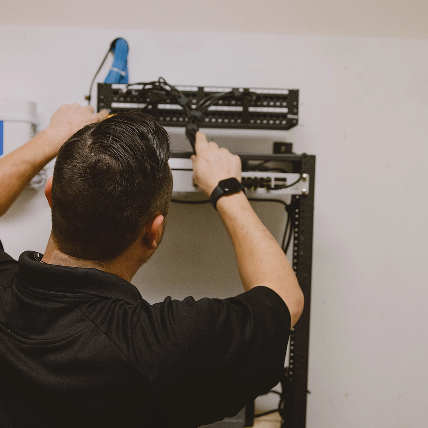 Vital Integrators technician installing network equipment