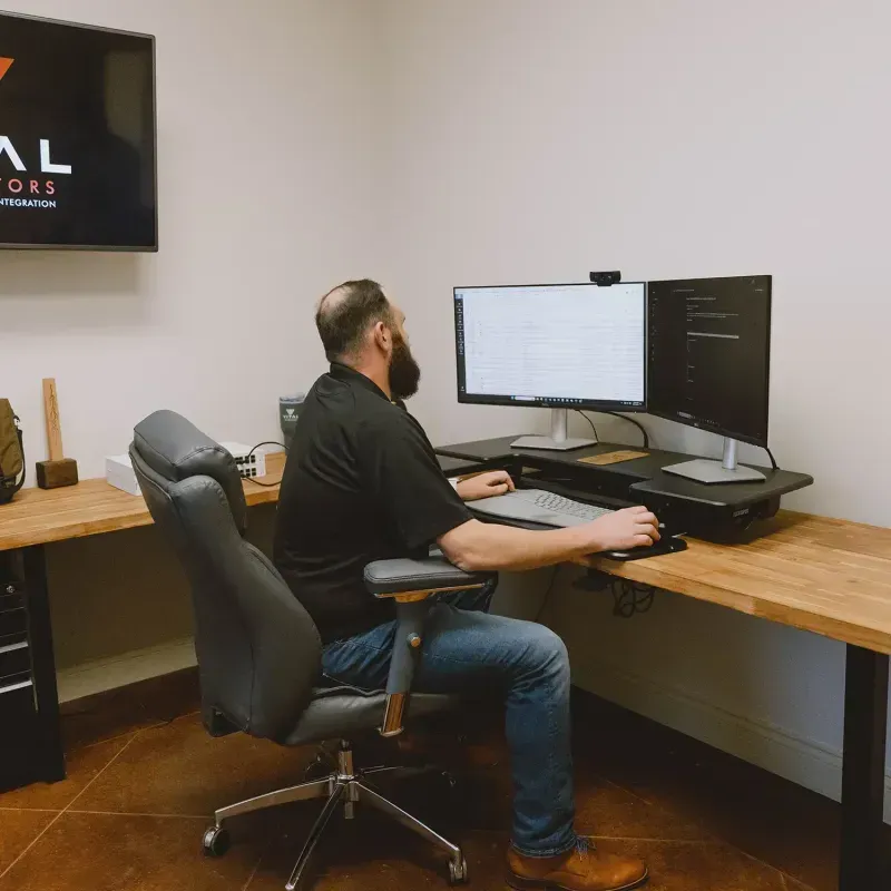 Vital Integrators technician at a multi-monitor workstation