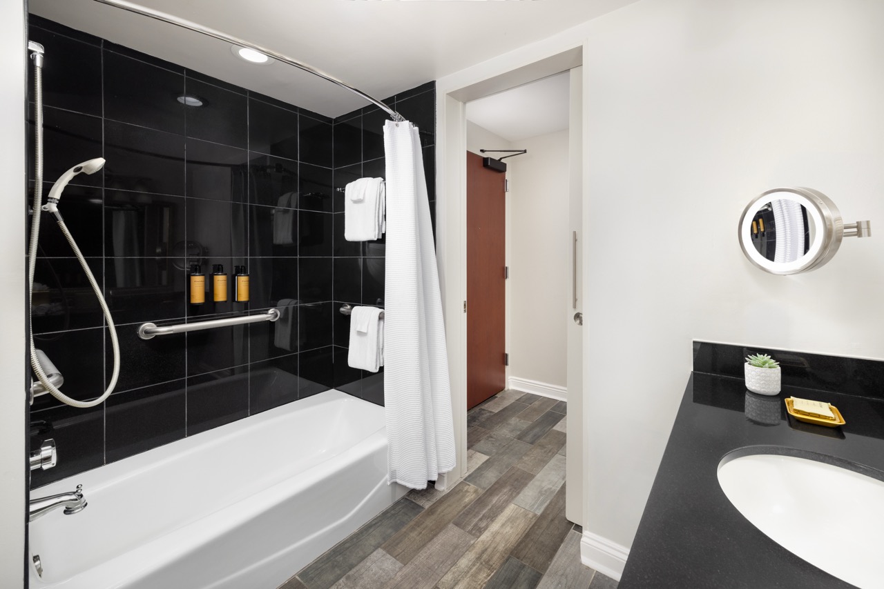 Deluxe King bathroom with shower, tub and sink