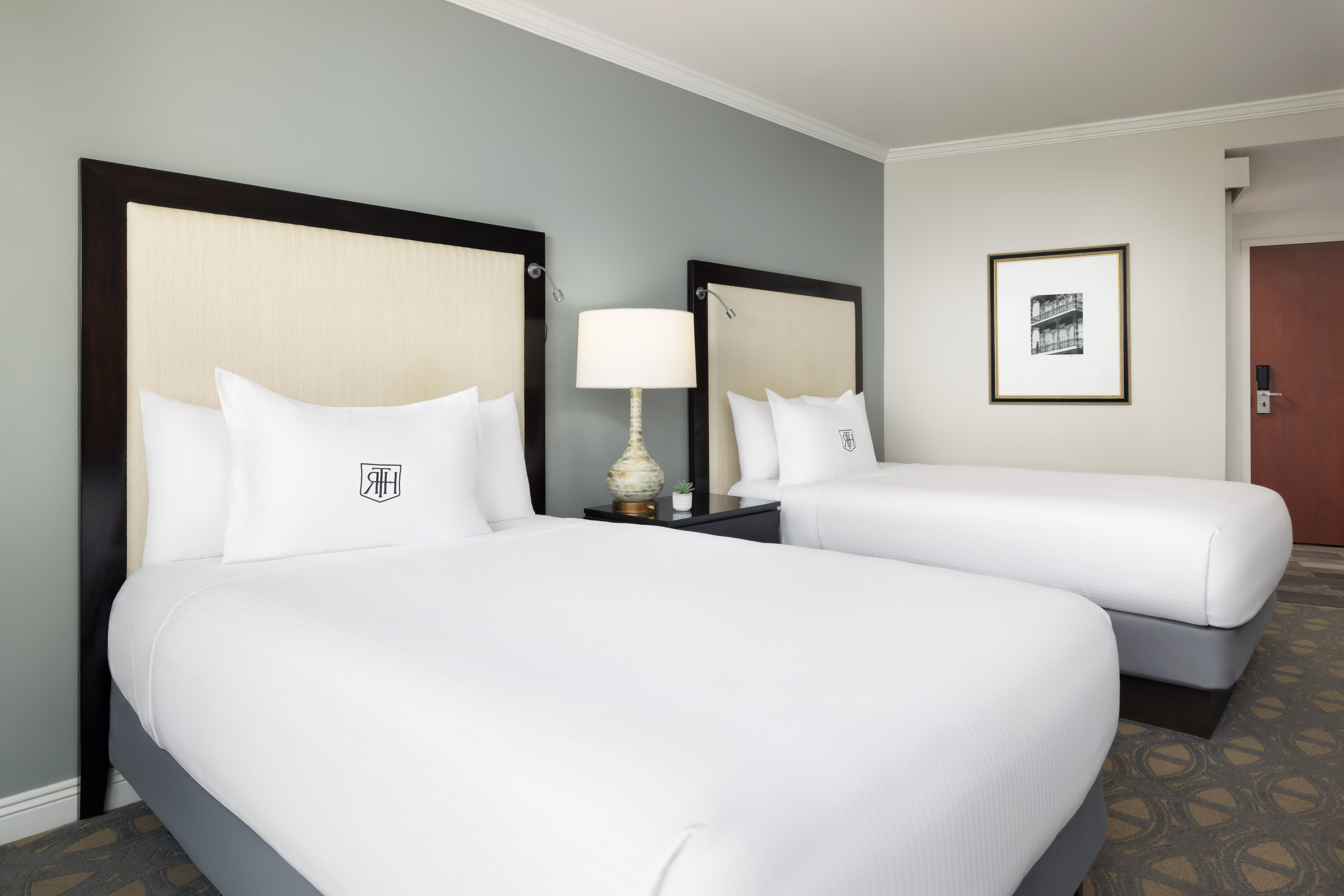 two bed room with embroidered pillows