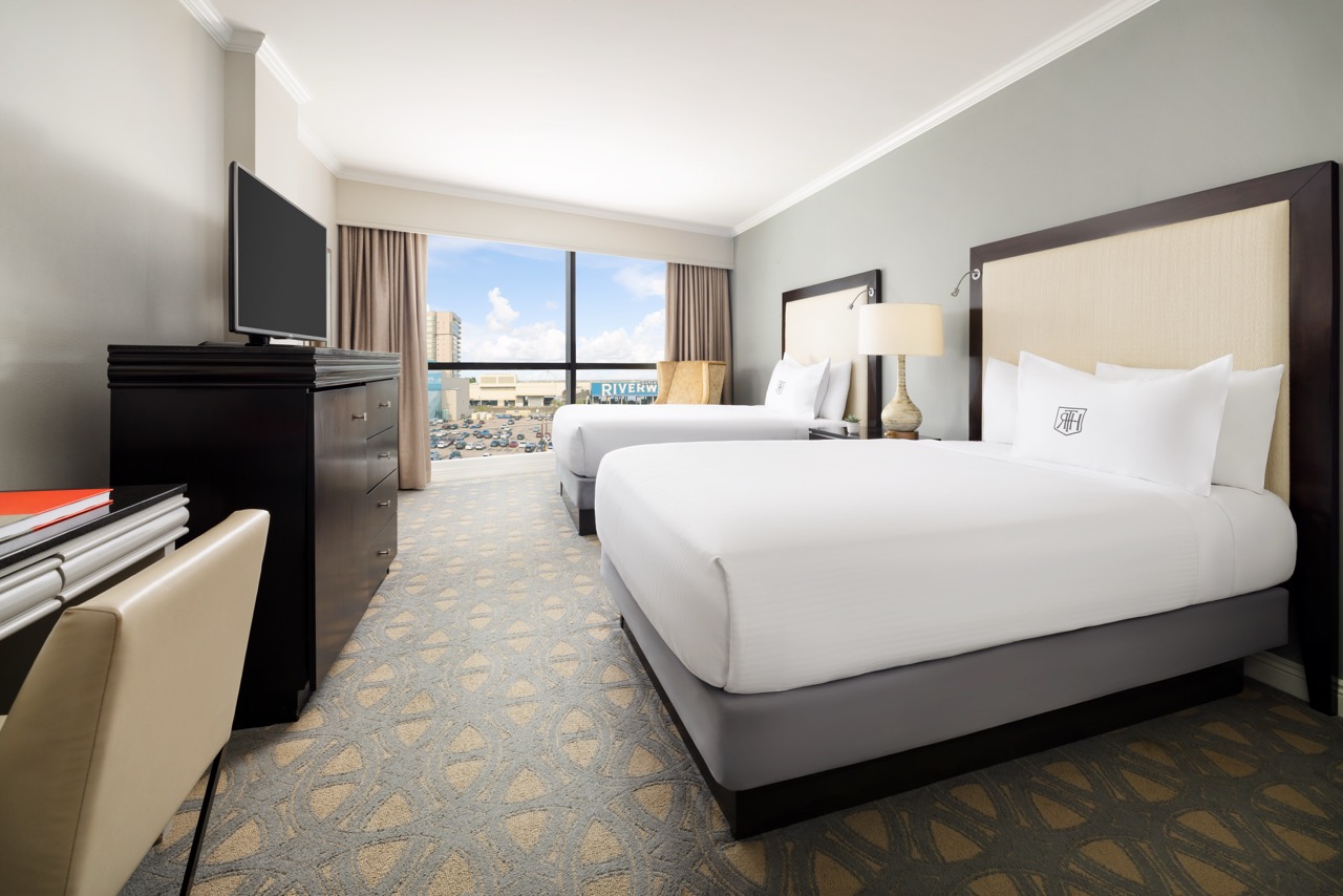 two beds with tv and window view