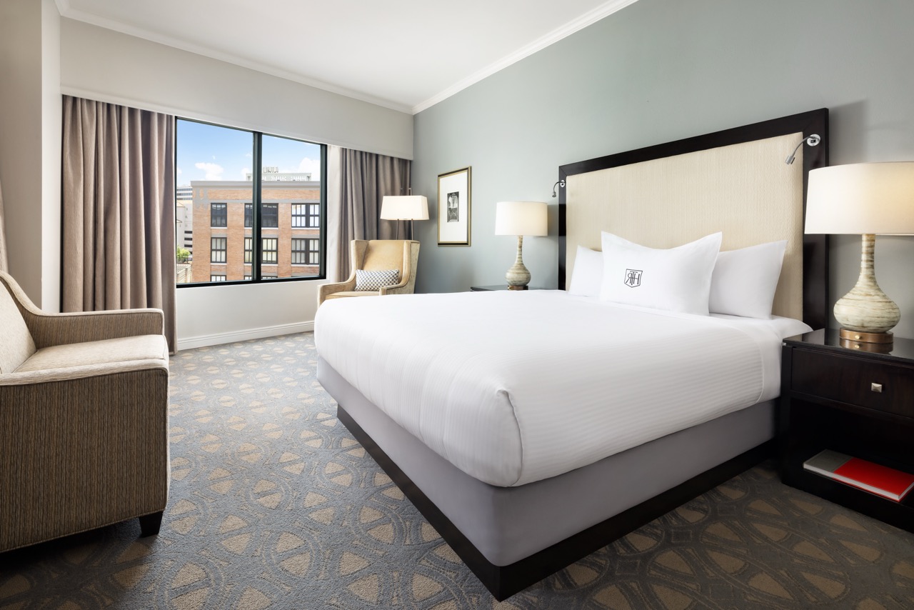 Premier King Executive bedroom with couch and window view
