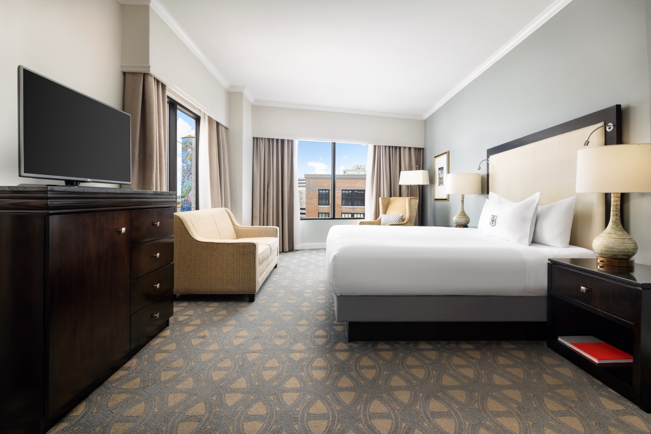 Premier King Executive bedroom with couch, tv and window