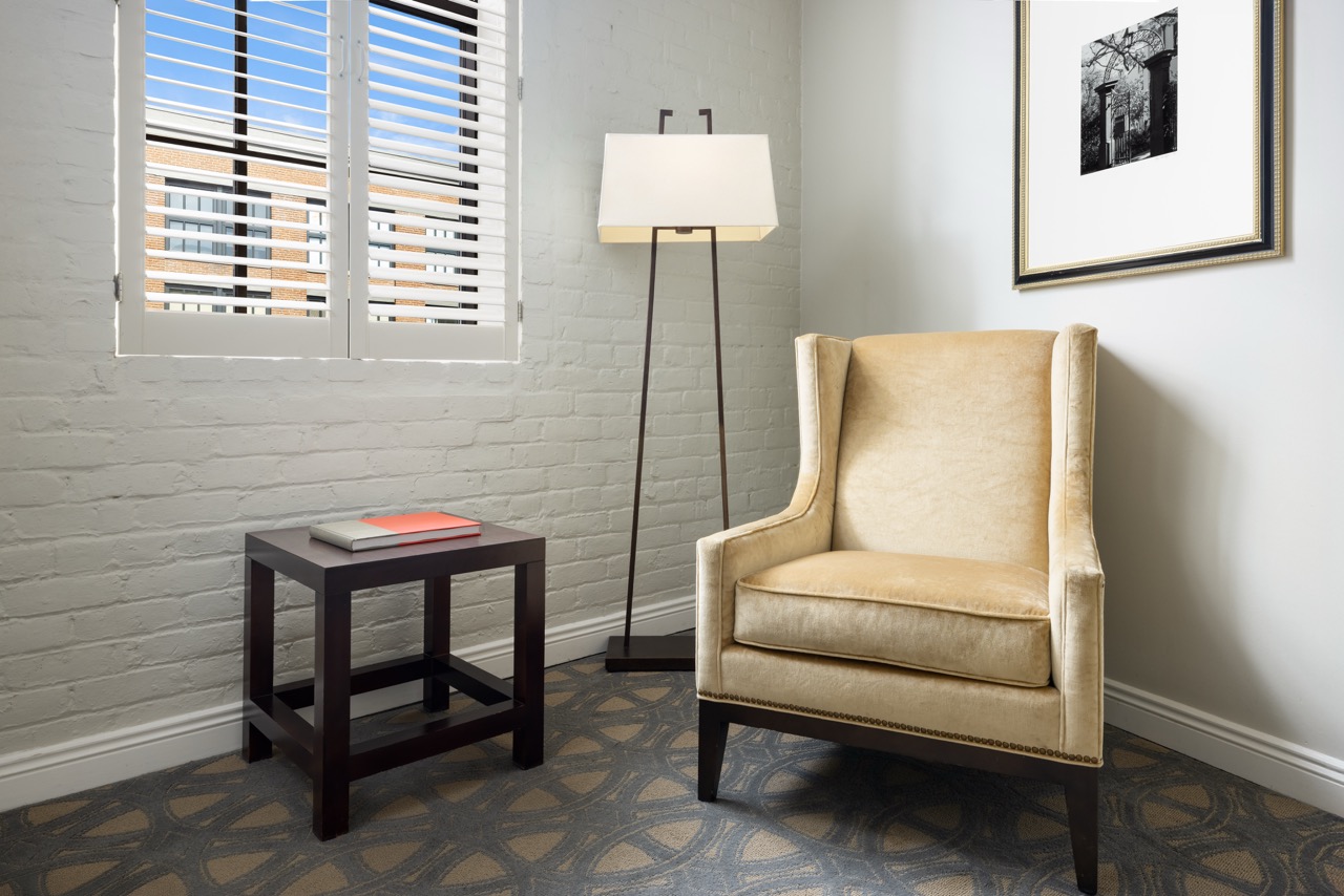 Premier King Executive seating area with lighting, book and artwork