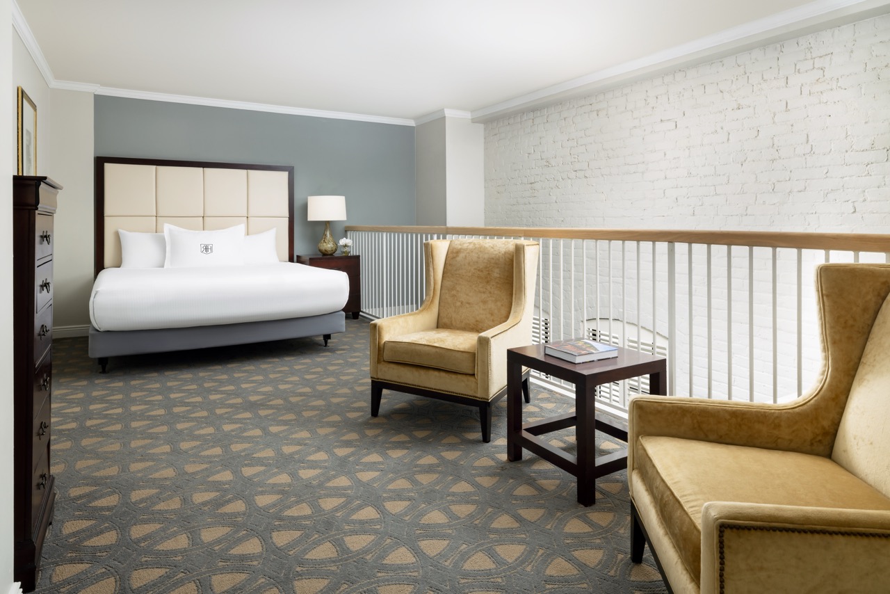 Hospitality Loft Suite second level with bedroom and seating