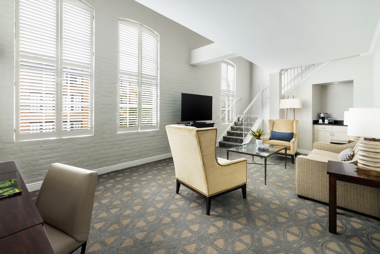 Hospitality Loft Suite with brick wall and stairs to second level
