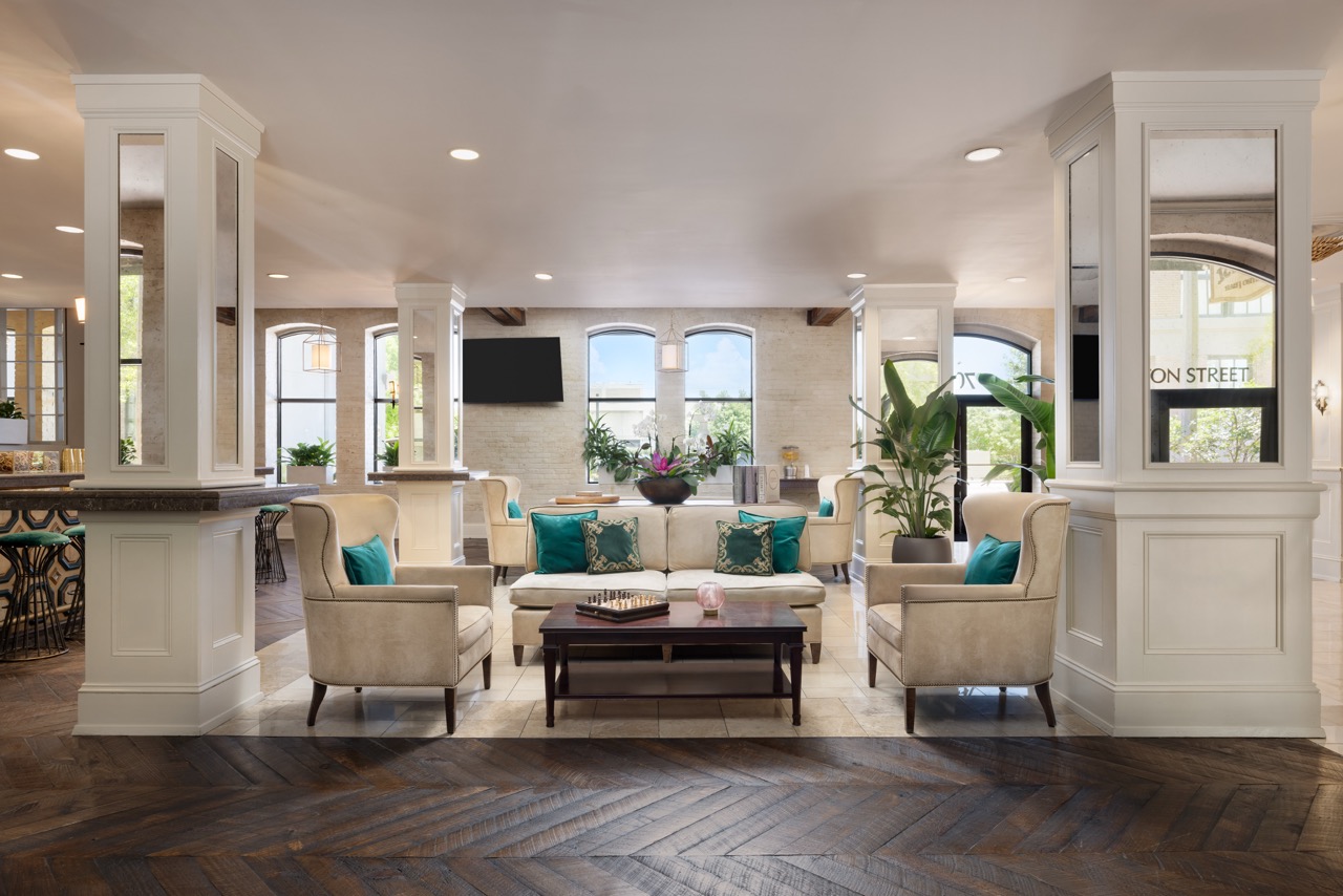 Lobby seating area next to bar with tvs