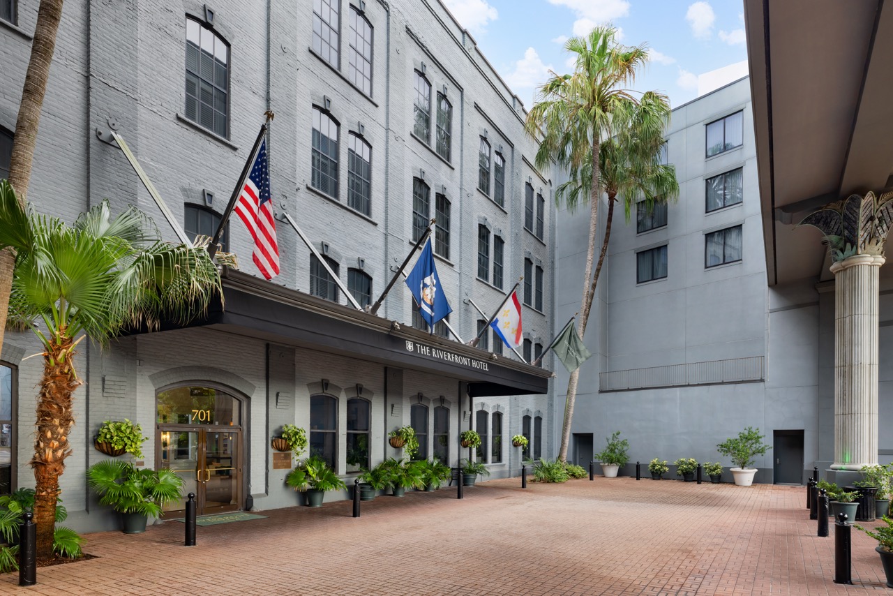 Riverfront Courtyard Entrance with flags and palm trees