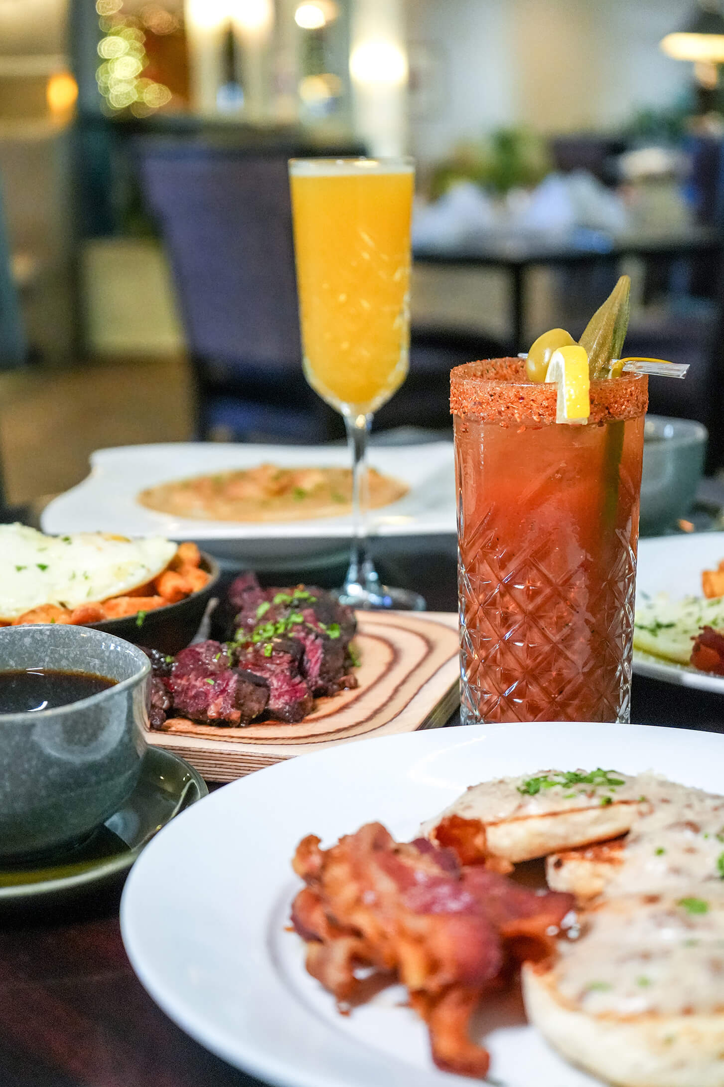 Steak, food and mixed drinks placed on table
