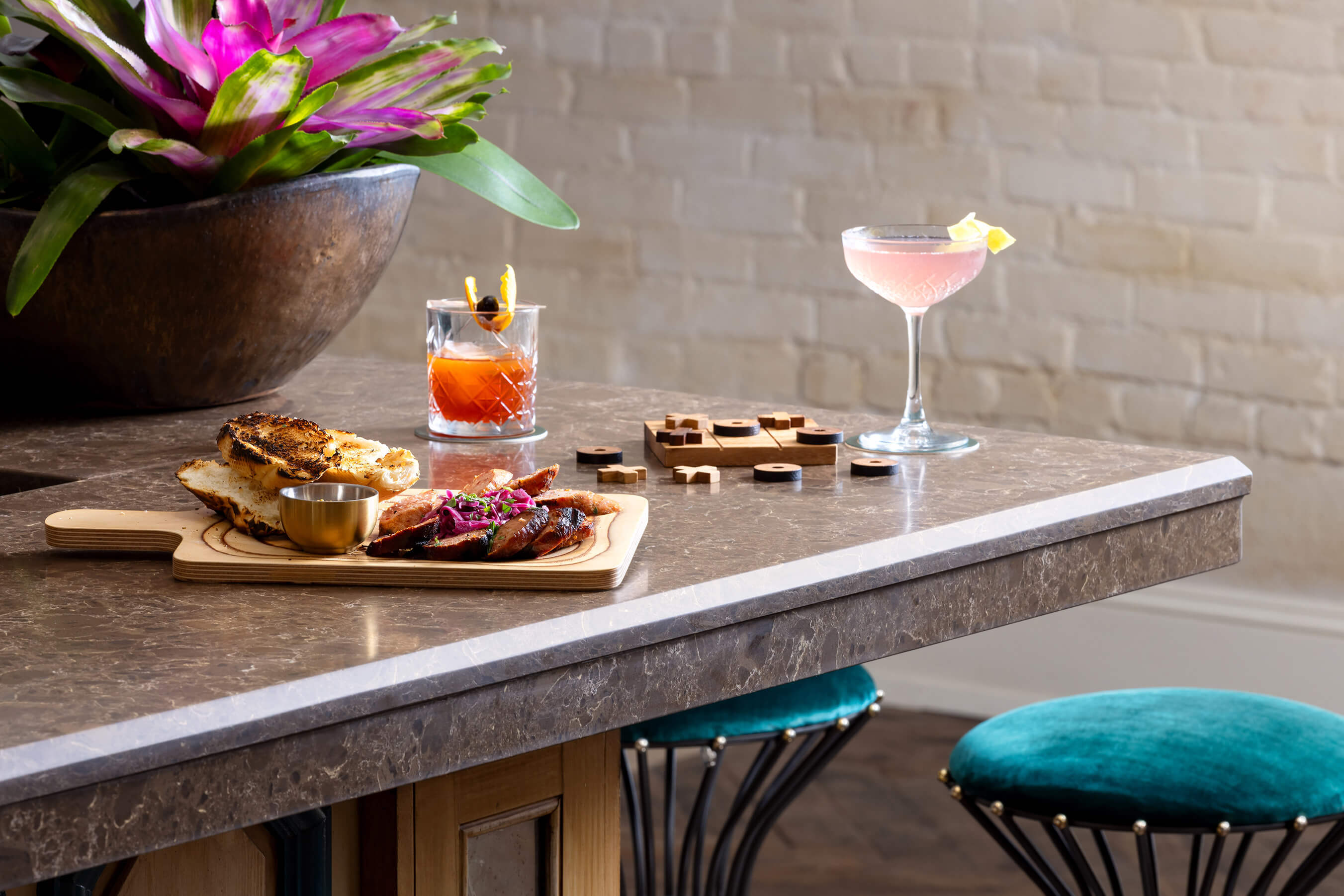 Mixed drinks, prepared food and game on table