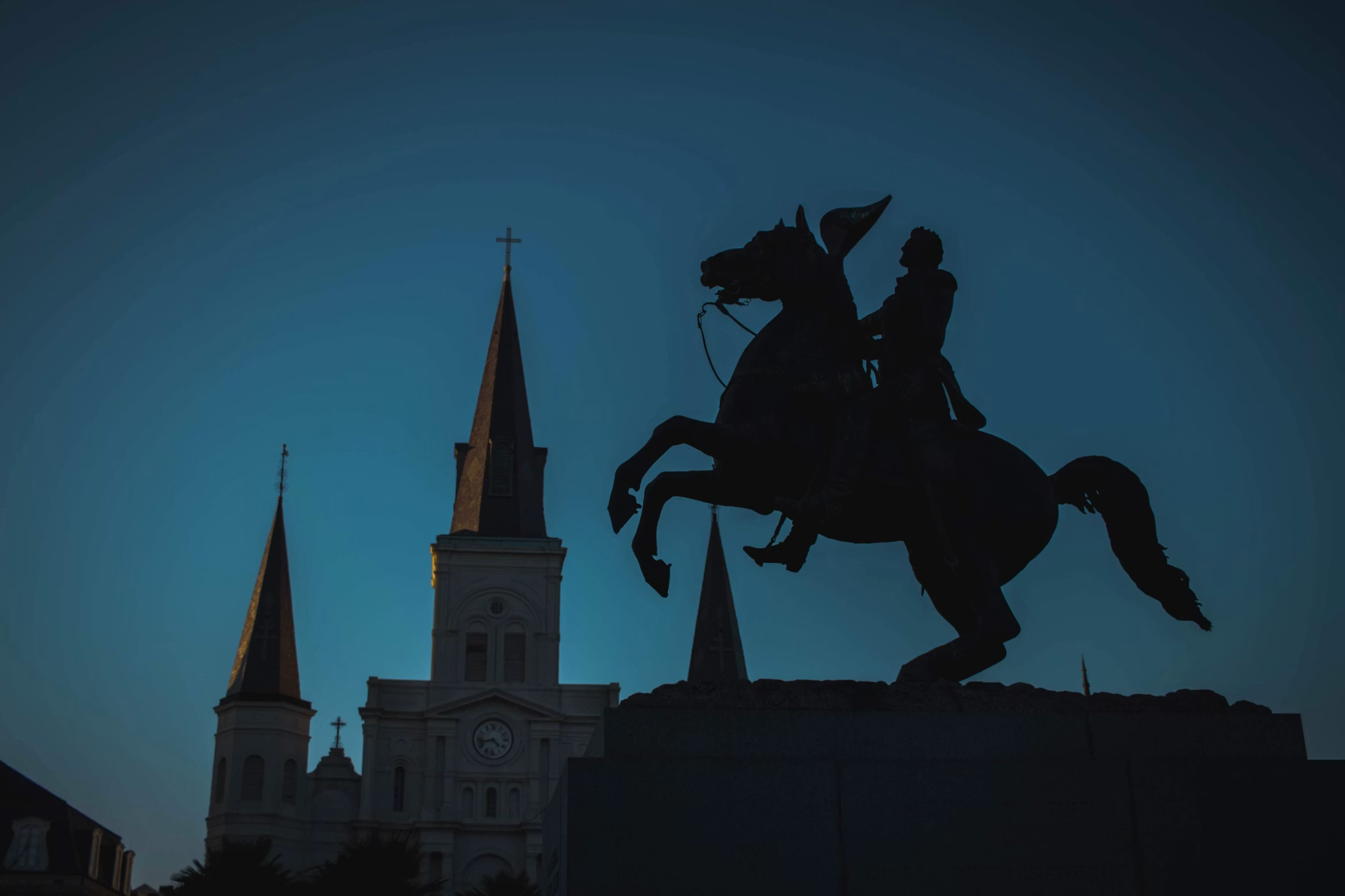 silhouette of rider horse statue and night
