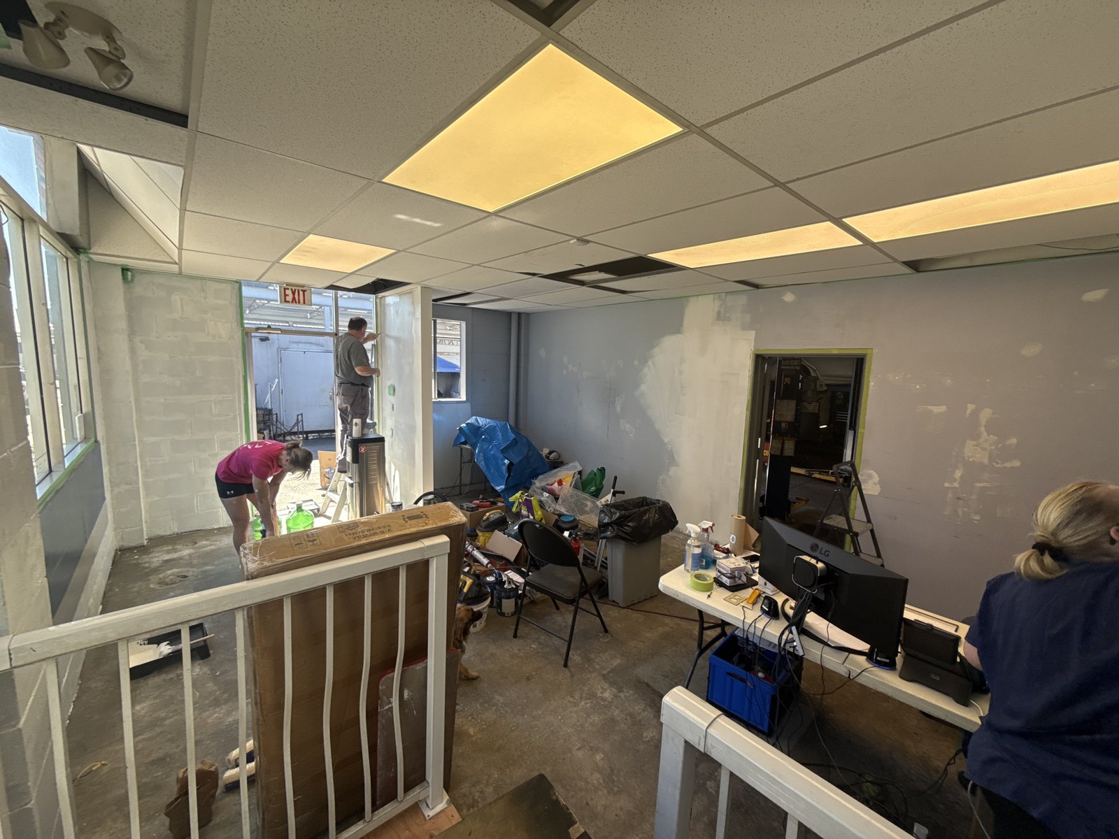 Front office walls patched and prepped for paint while the team works