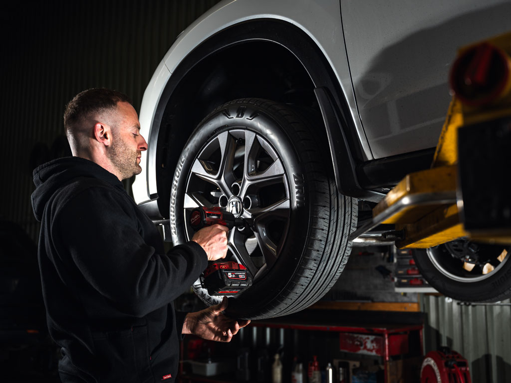 Mechanic loosening bolts during tyre fitting at Modbury Motors