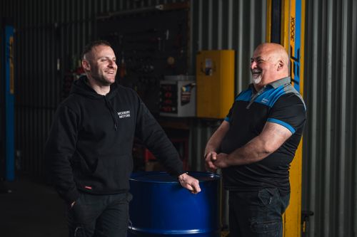 Father and son discussing vehicle servicing at Modbury Motors workshop
