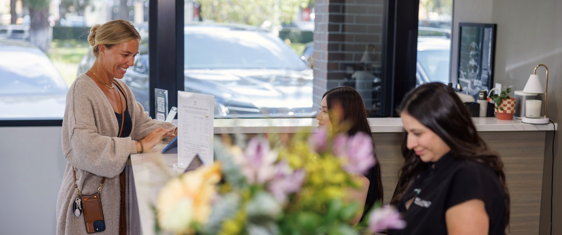 A patient checking out at the Belle Vie front desk