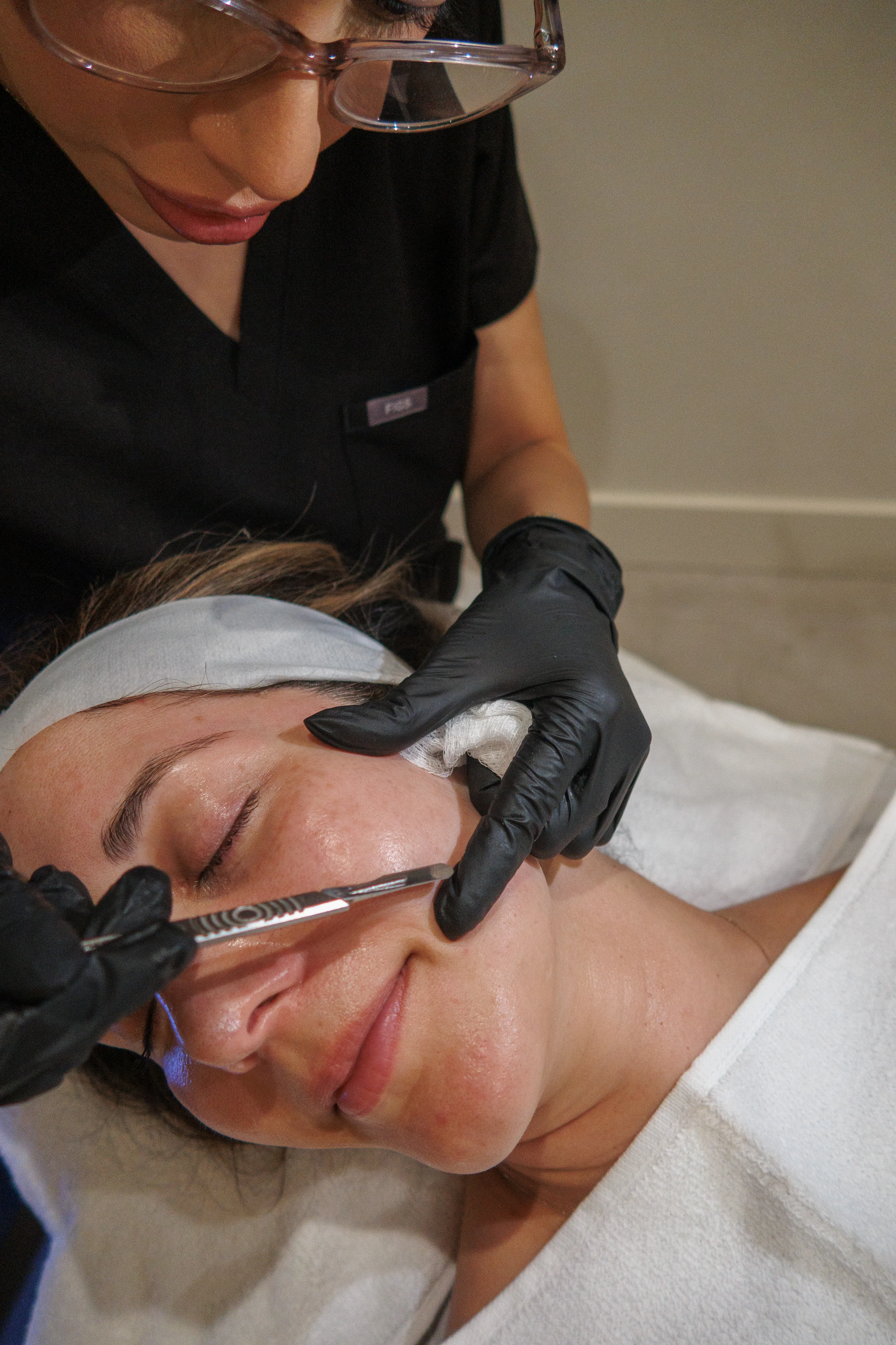 Belle Vie provider performing dermaplaning during a facial visit