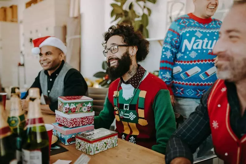 people wearing Christmas hat and gifts placed on the table.