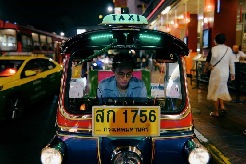 A man is waiting for passengers in the rickshaw