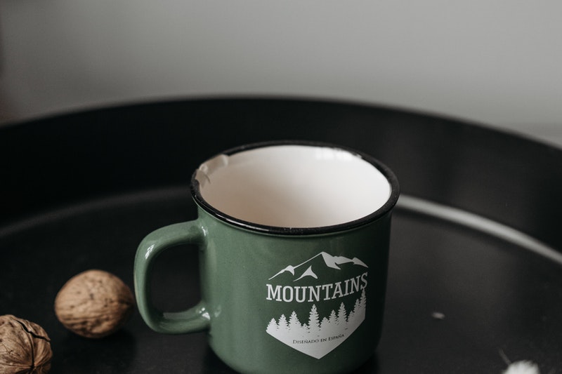 A Printed Mug Quoted With "Mountains"