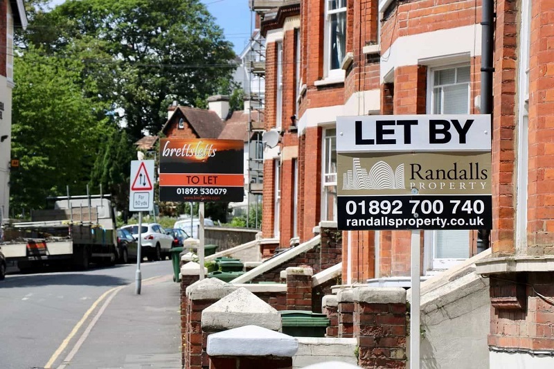Hanging Boards of To Let Services Display At Street Outside of Houses