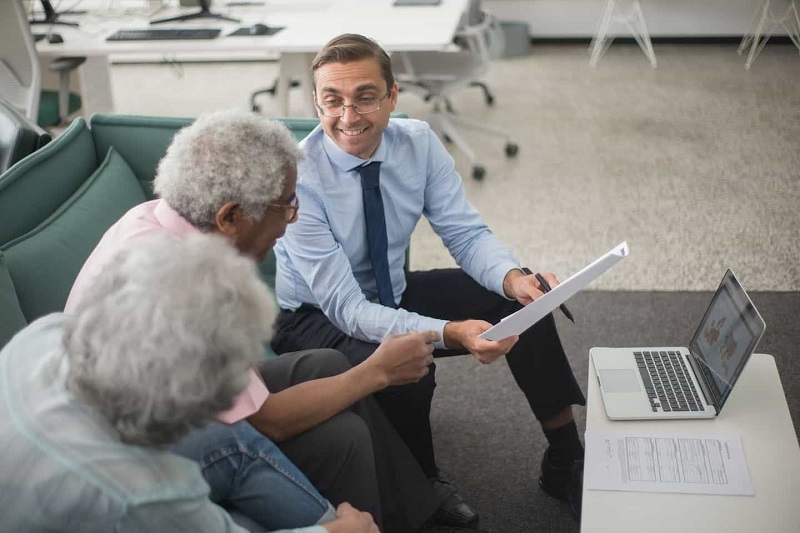 Insurance Agent is Explaining Policy to Old People