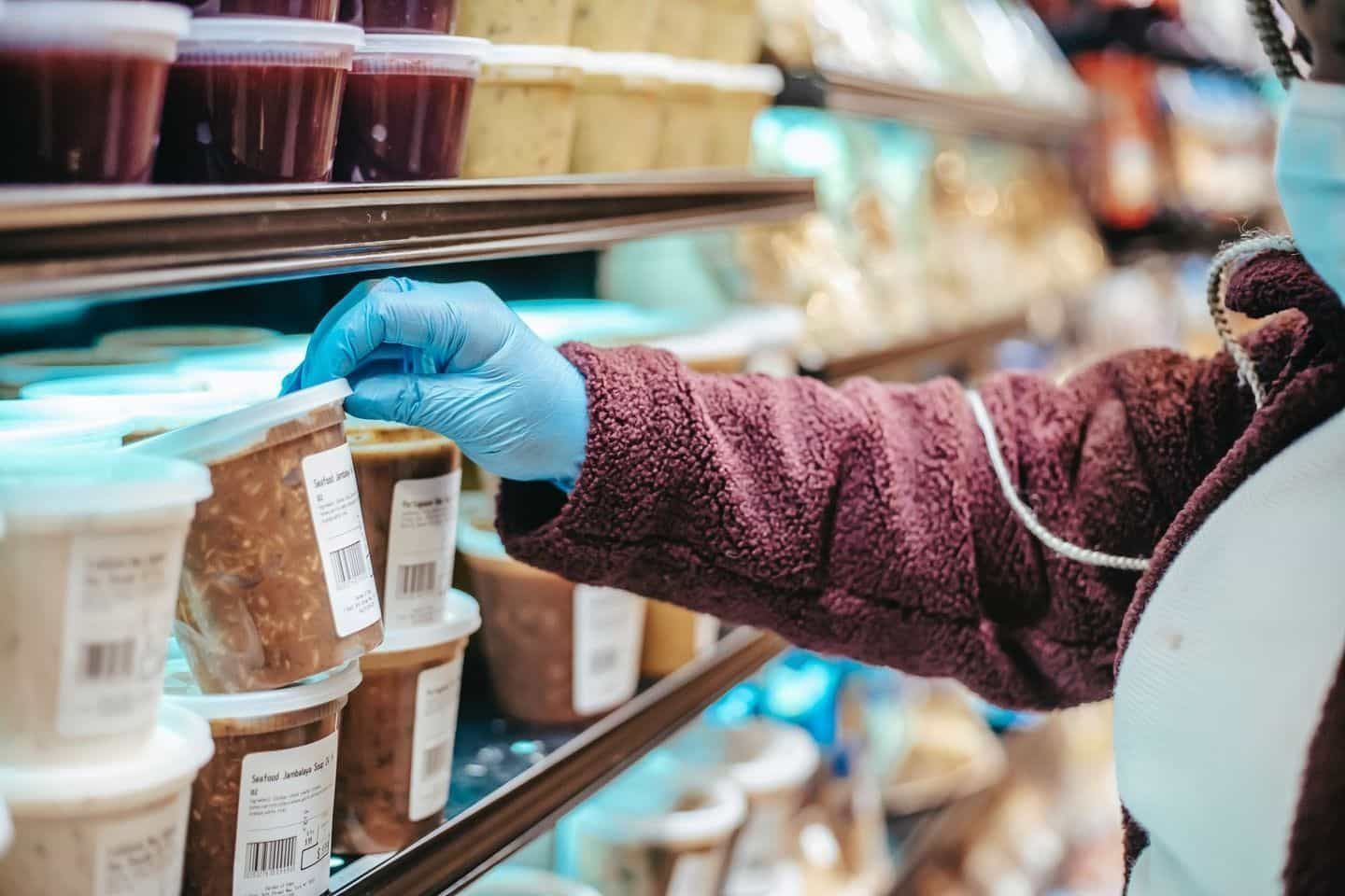 A Lady Checking FMCG Product With Wearing Gloves and Mask