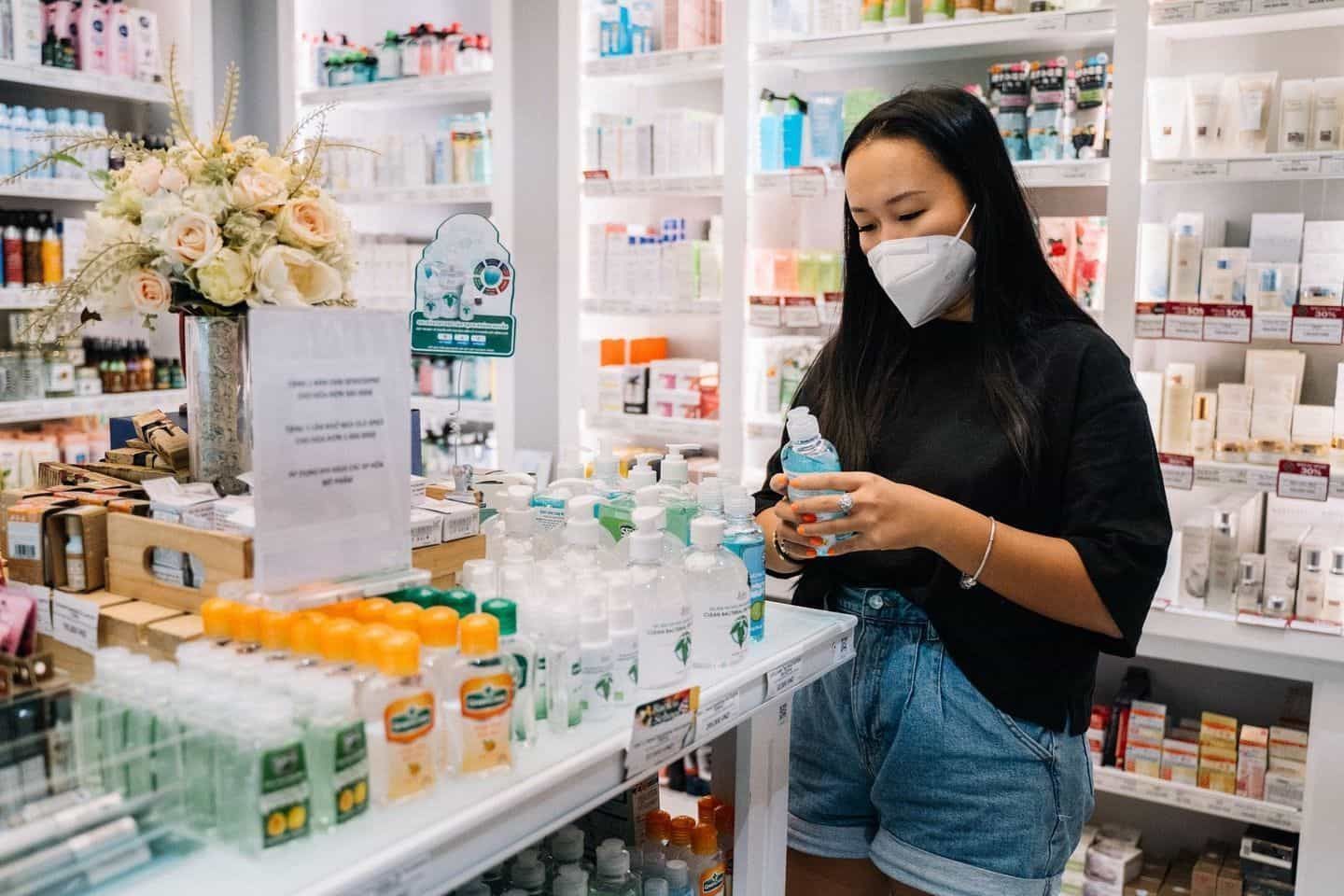 A Woman Checking Hand Sanitizer in Pahrma Store