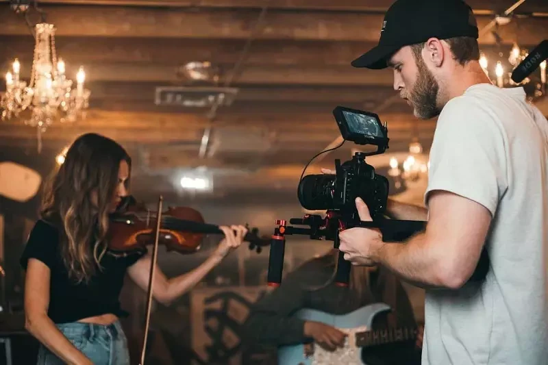 A Photographer Capturing A Photo of Playing Violin Girl