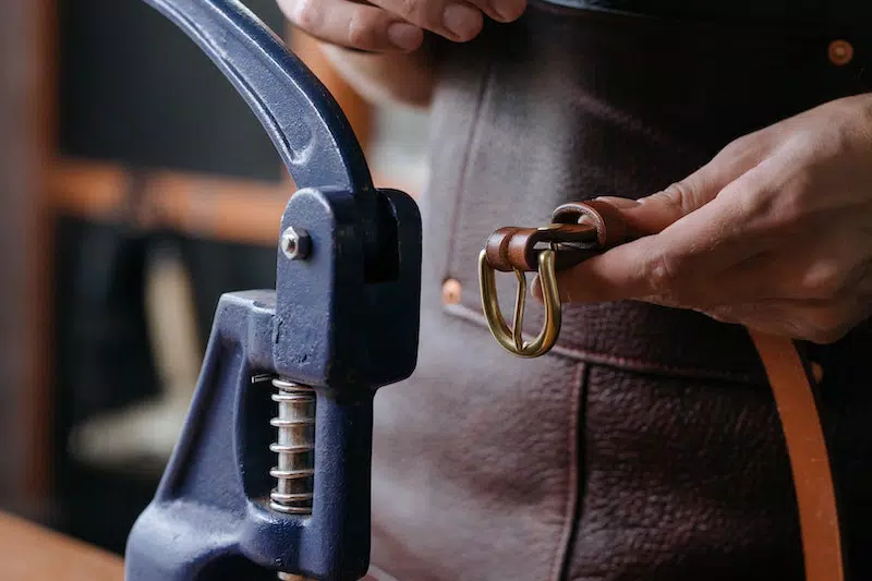 A man making belt buckle 