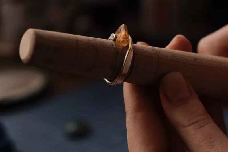 A man is making a jewellery in the wood
