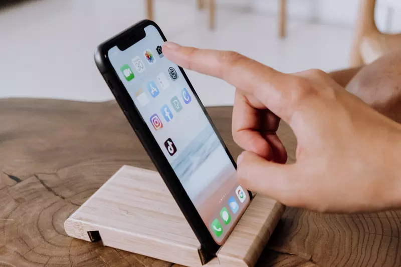 Someone is using phone placed on the table