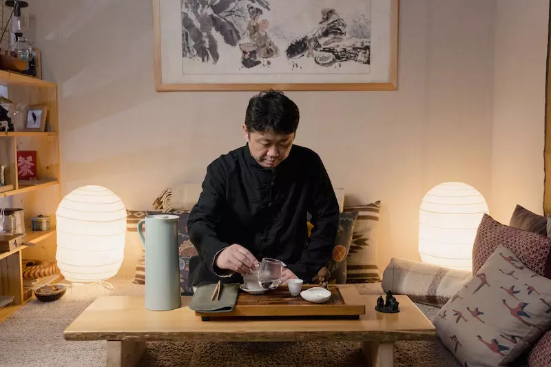 A man drinking tea in the house