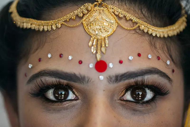 A lady with the bindi is shown in the image