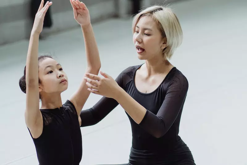 A lady is teaching dance steps to her student