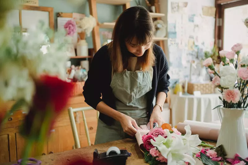 A lady is making the bouquet