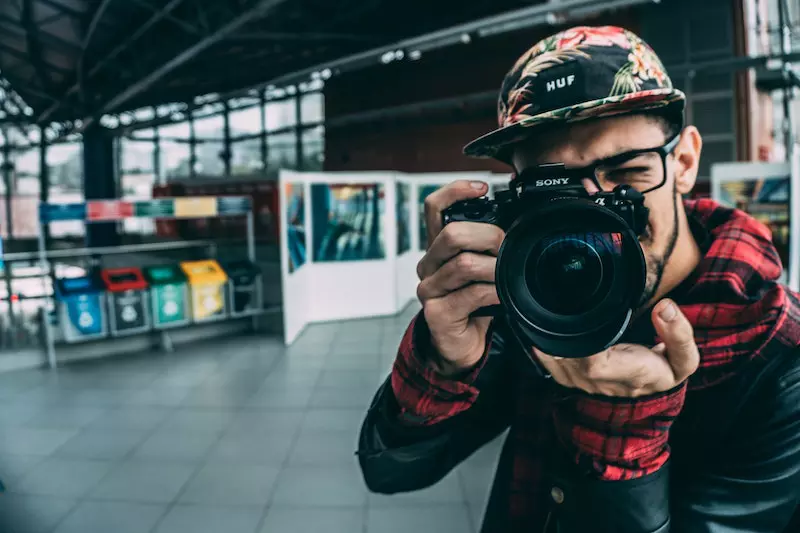 A man is clicking picture with his camera