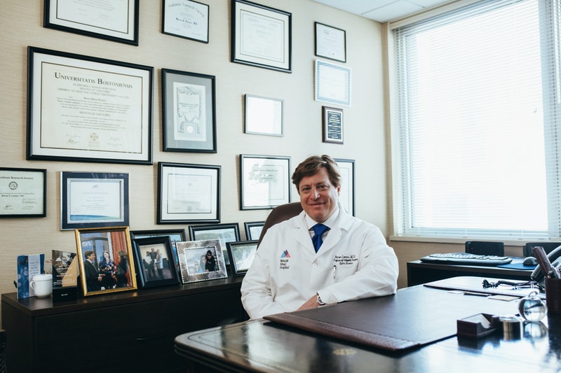 A doctor is sitting in his office.