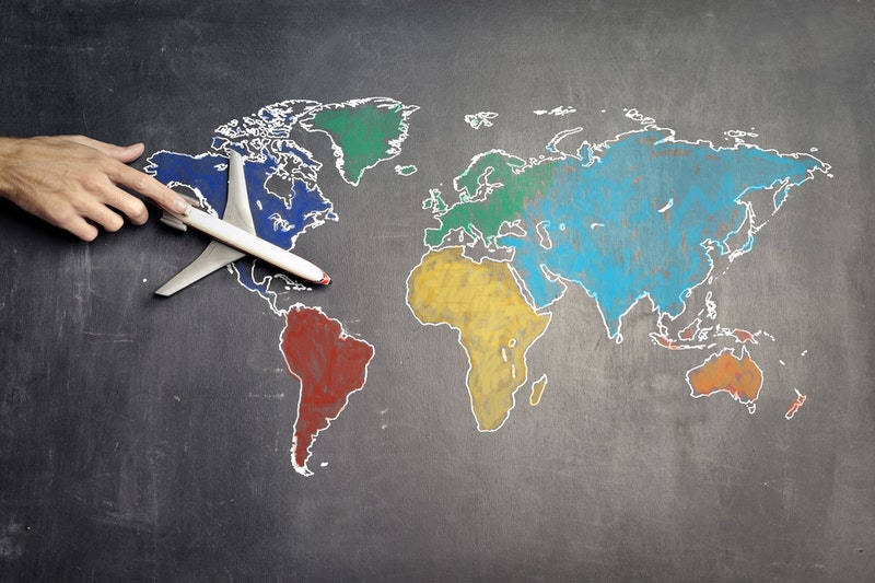 A toy of an airplane placed on the world map.