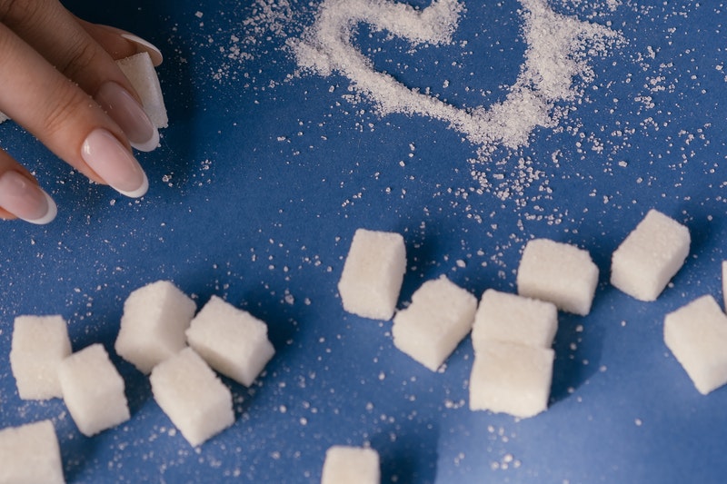 Sugar cubes spreaded on the table.
