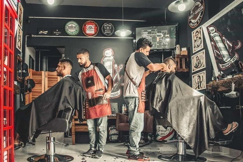 Barber is cutting hairs of mens in the salon