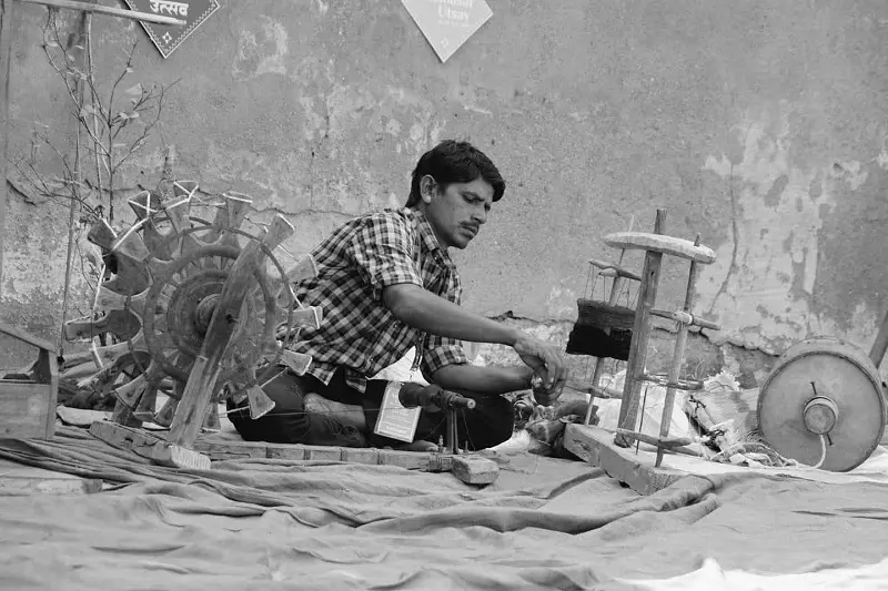 A man working on handloom.