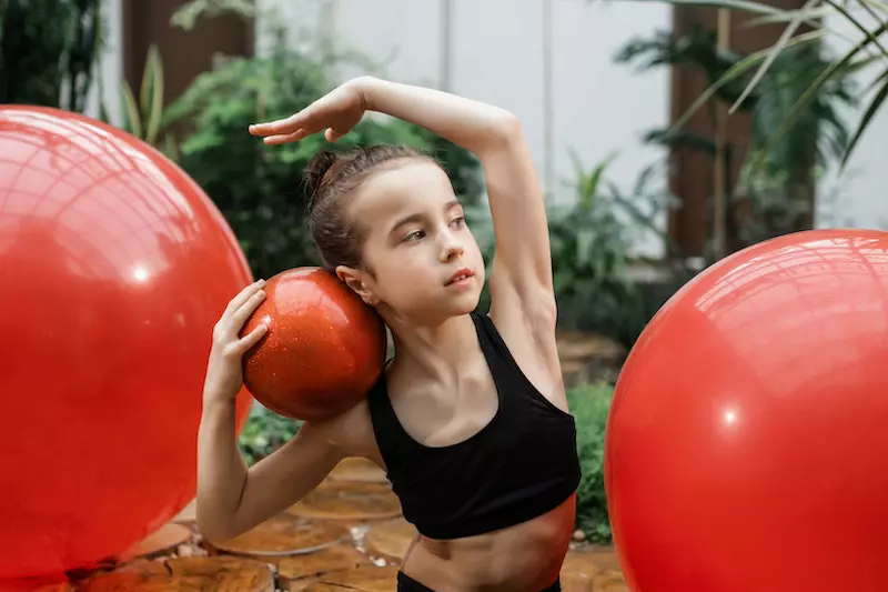 A kids playing with balls
