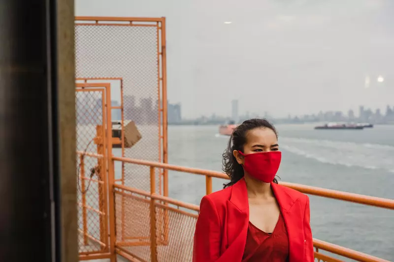 A woman wearing face mask on ferry is shown in the image